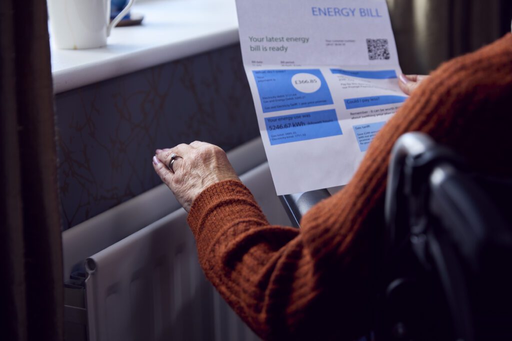 Close Up Of Senior Woman In Wheelchair With Energy Bill